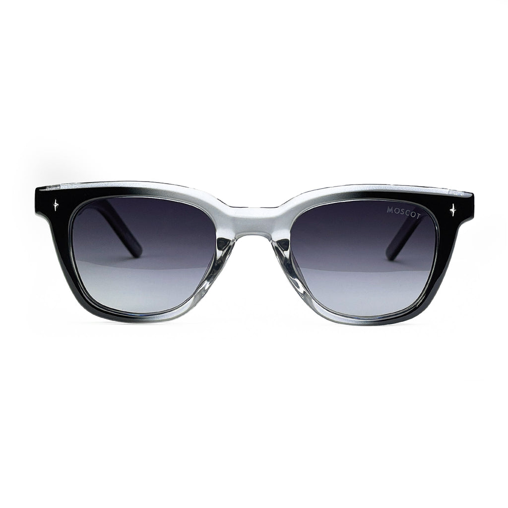 Black and clear acetate square sunglasses with gradient lenses on white background