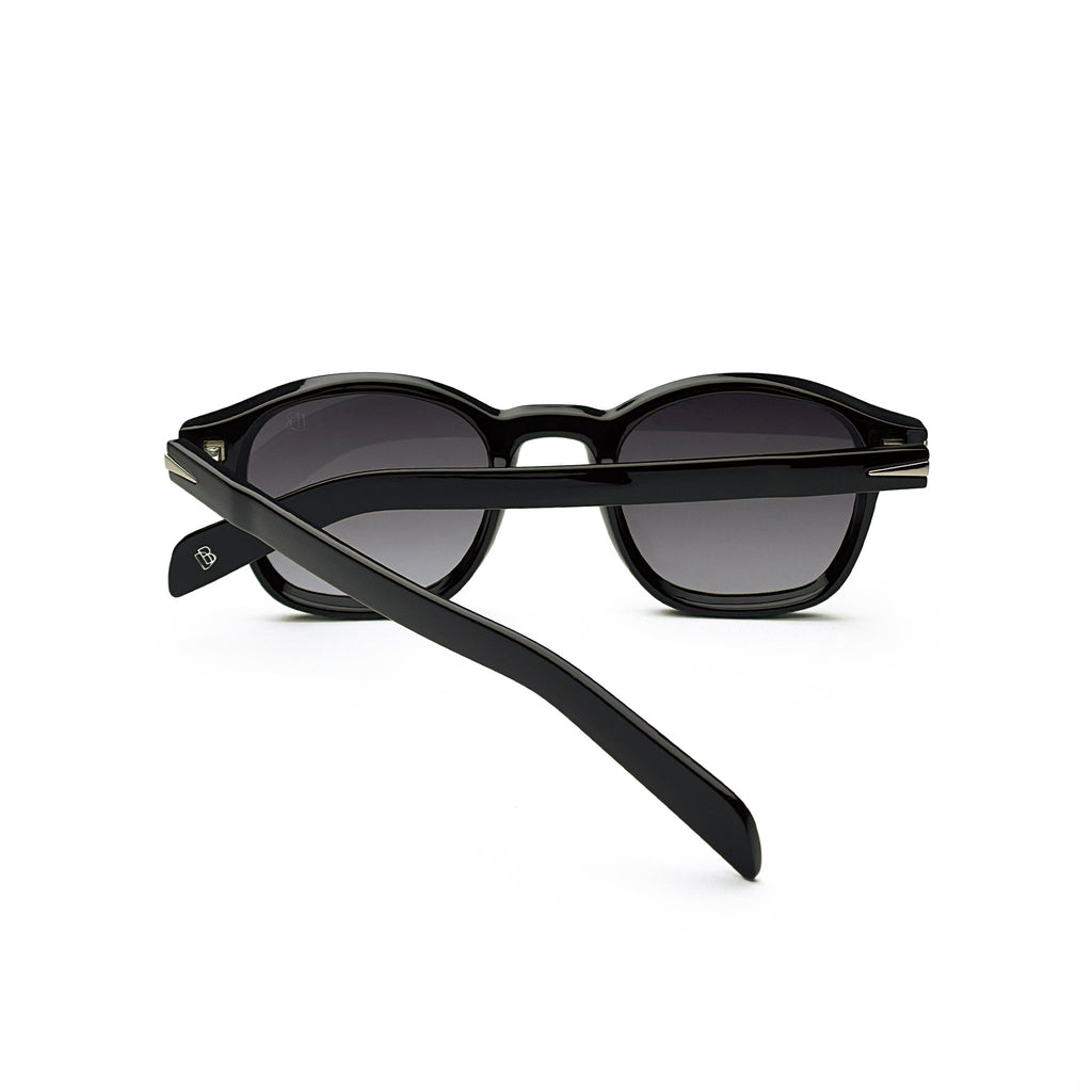 Black round sunglasses with dark lenses and thick frames on white background