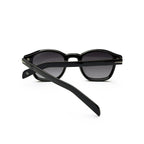 Black round sunglasses with dark lenses and thick frames on white background