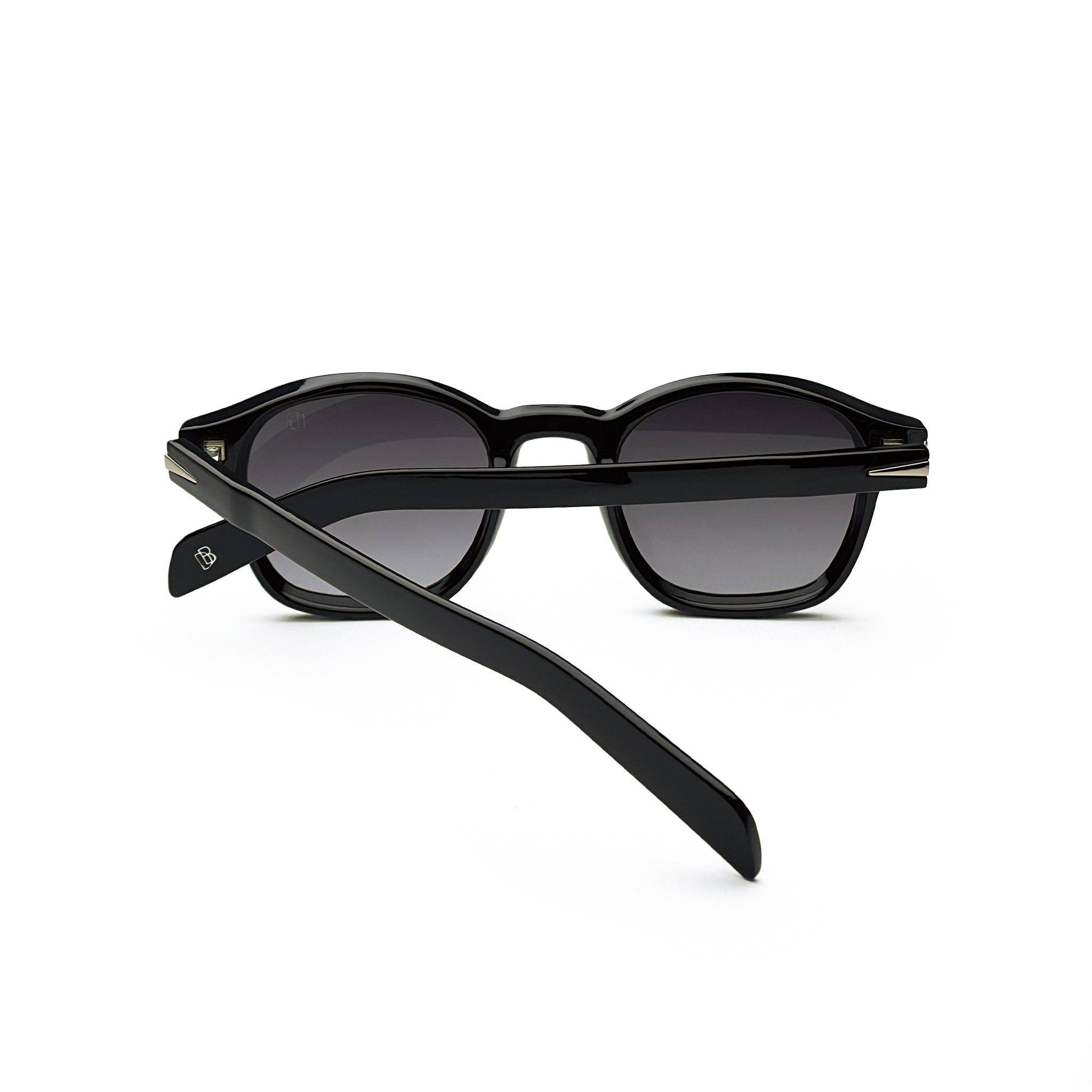 Black round sunglasses with dark lenses and thick frames on white background