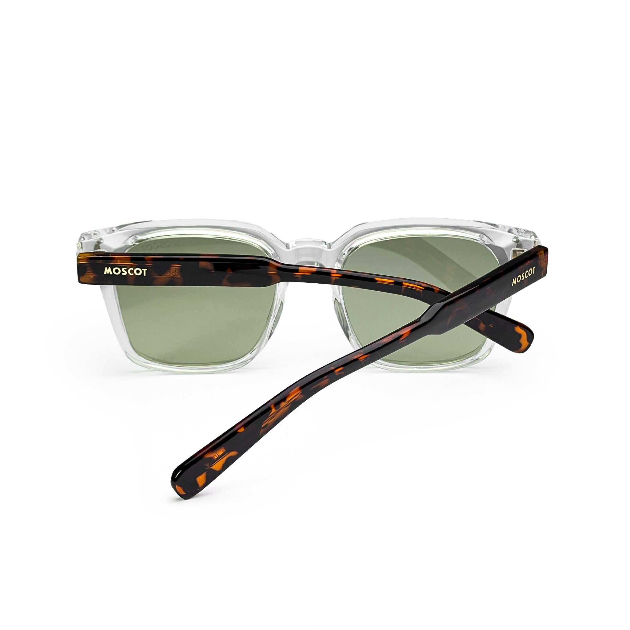 Clear square sunglasses with green lenses and tortoiseshell arms on white background