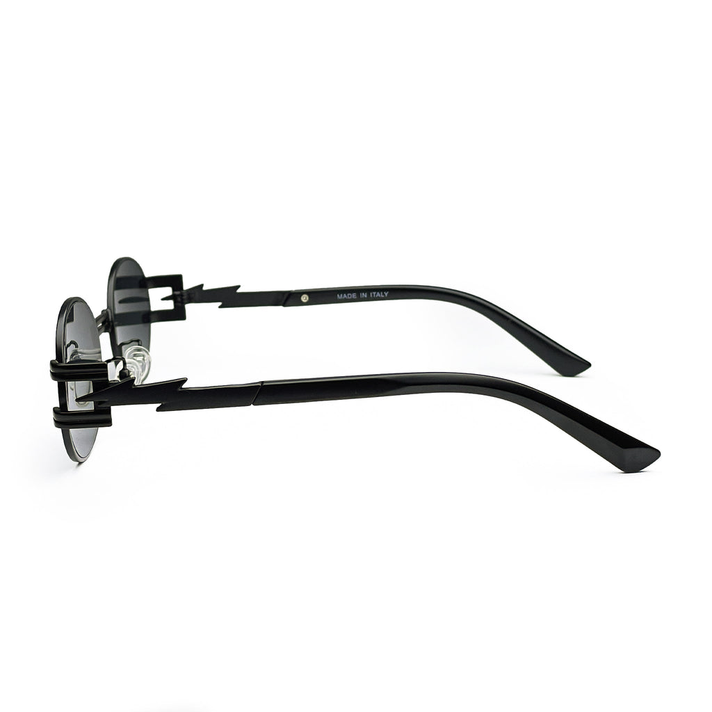 Side view of black sunglasses with zigzag temple arms and round dark lenses on white background