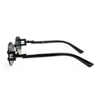 Side view of black sunglasses with zigzag temple arms and round dark lenses on white background