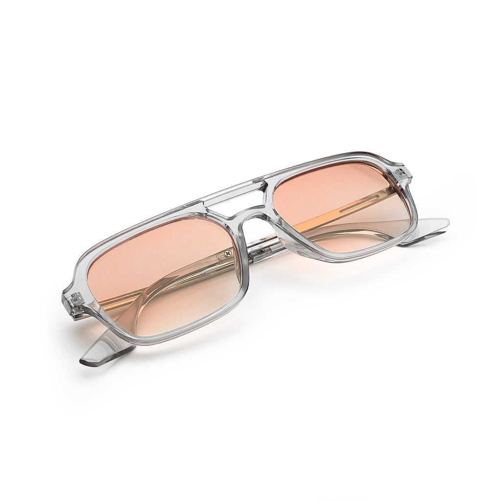 Rectangular sunglasses with transparent frame and pink tinted lenses on white background