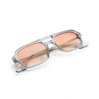 Rectangular sunglasses with transparent frame and pink tinted lenses on white background