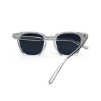 Clear frame sunglasses with dark lenses, one temple arm crossed, on white background