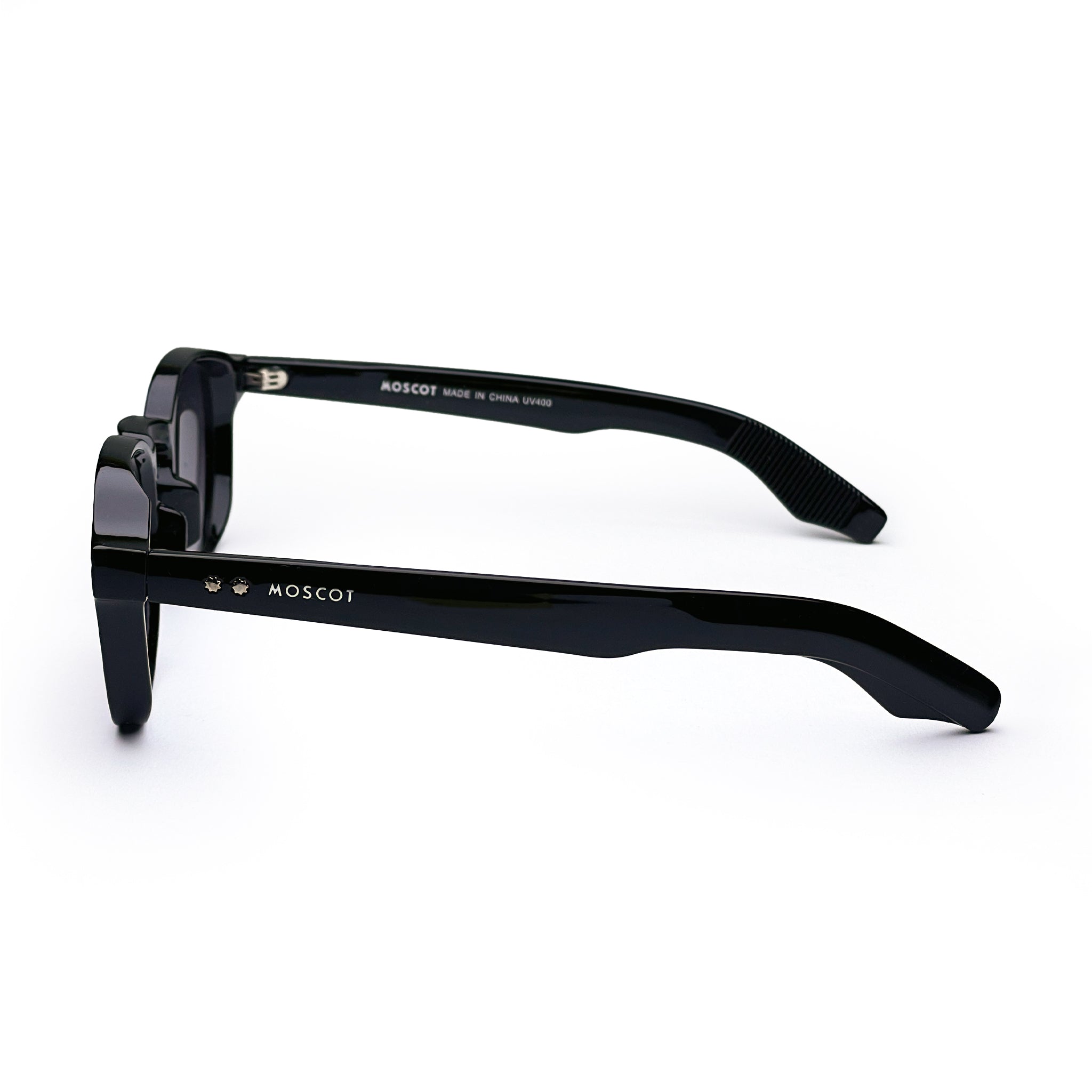Black MOSCOT sunglasses with thick frames and logo detail, side view on white background