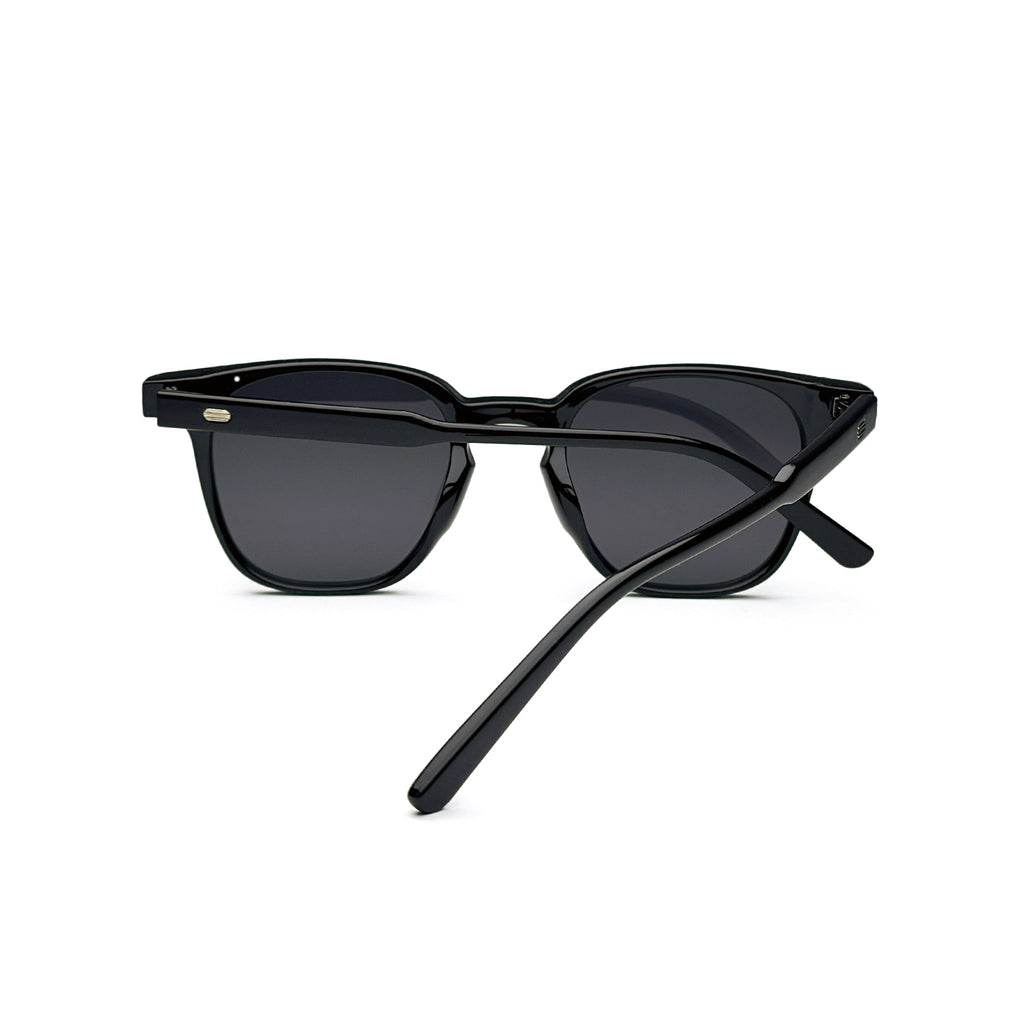 Black square sunglasses with dark lenses and glossy acetate frame on white background