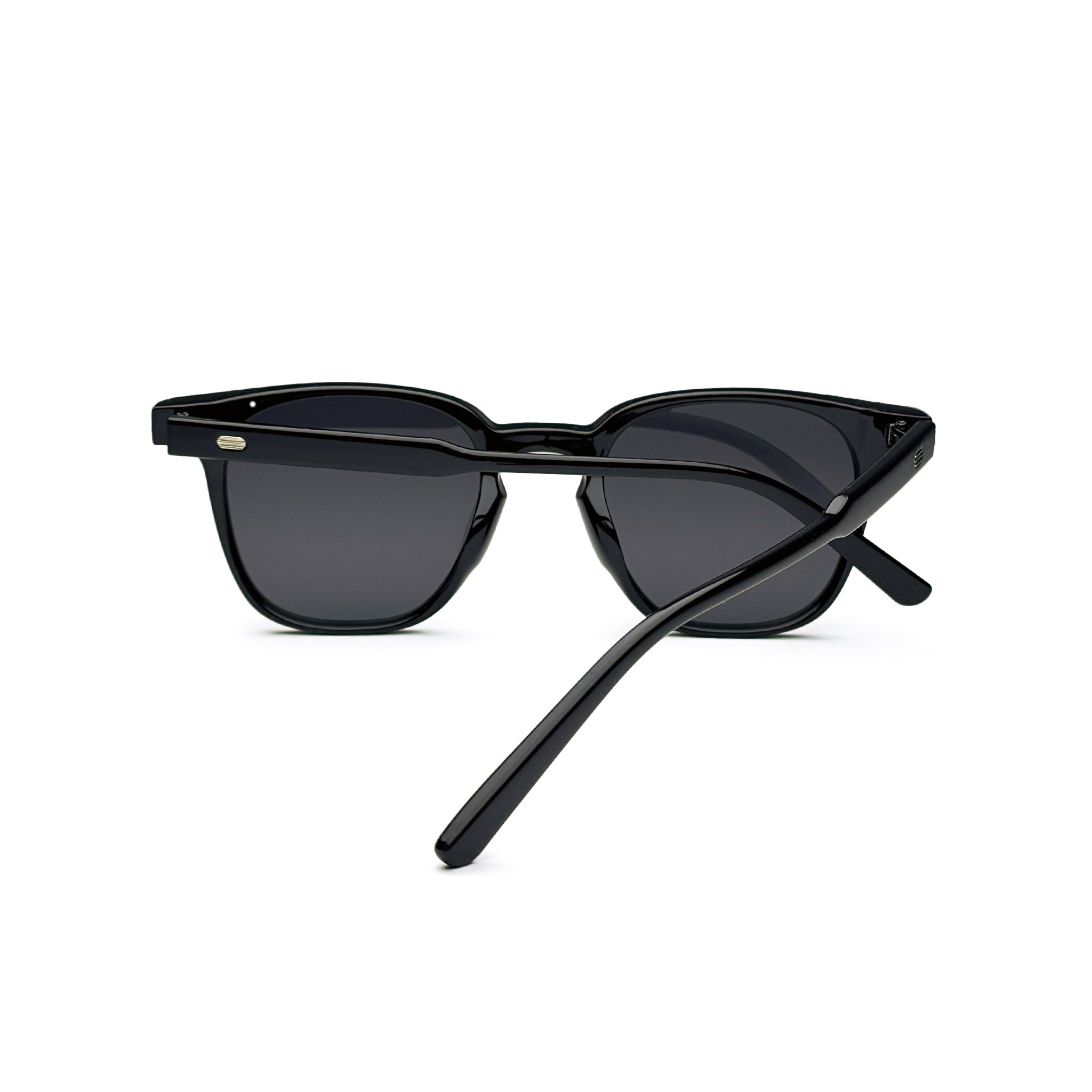 Black square sunglasses with dark lenses and glossy acetate frame on white background