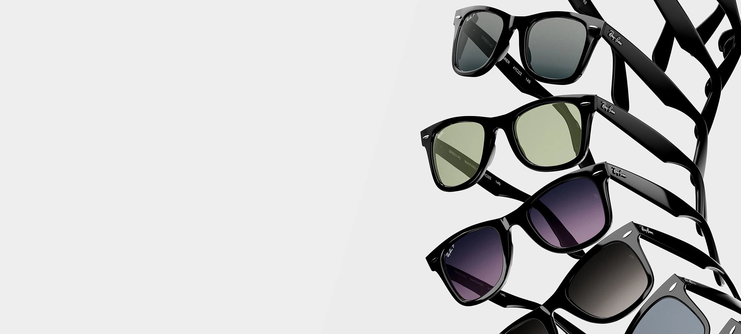 Stack of black wayfarer sunglasses with green, grey, purple, and blue tinted lenses